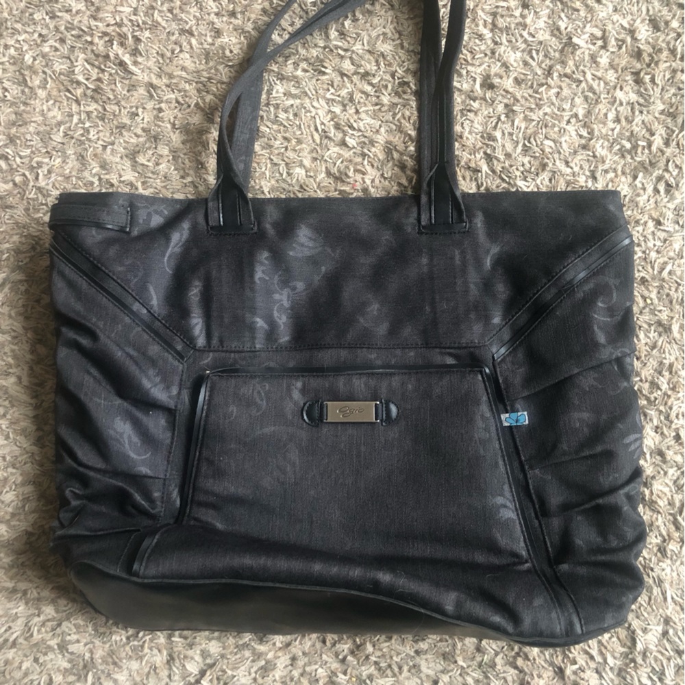 Travel tote by OGIO.  Black with floral pattern. Hold lap top & tons of pockets